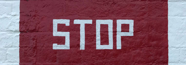 Stop written onto wall