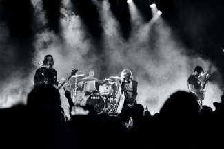 Band on stage during live performance in black and white